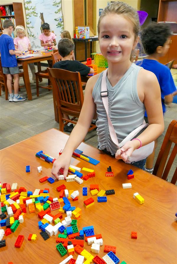 student with colorful blocks